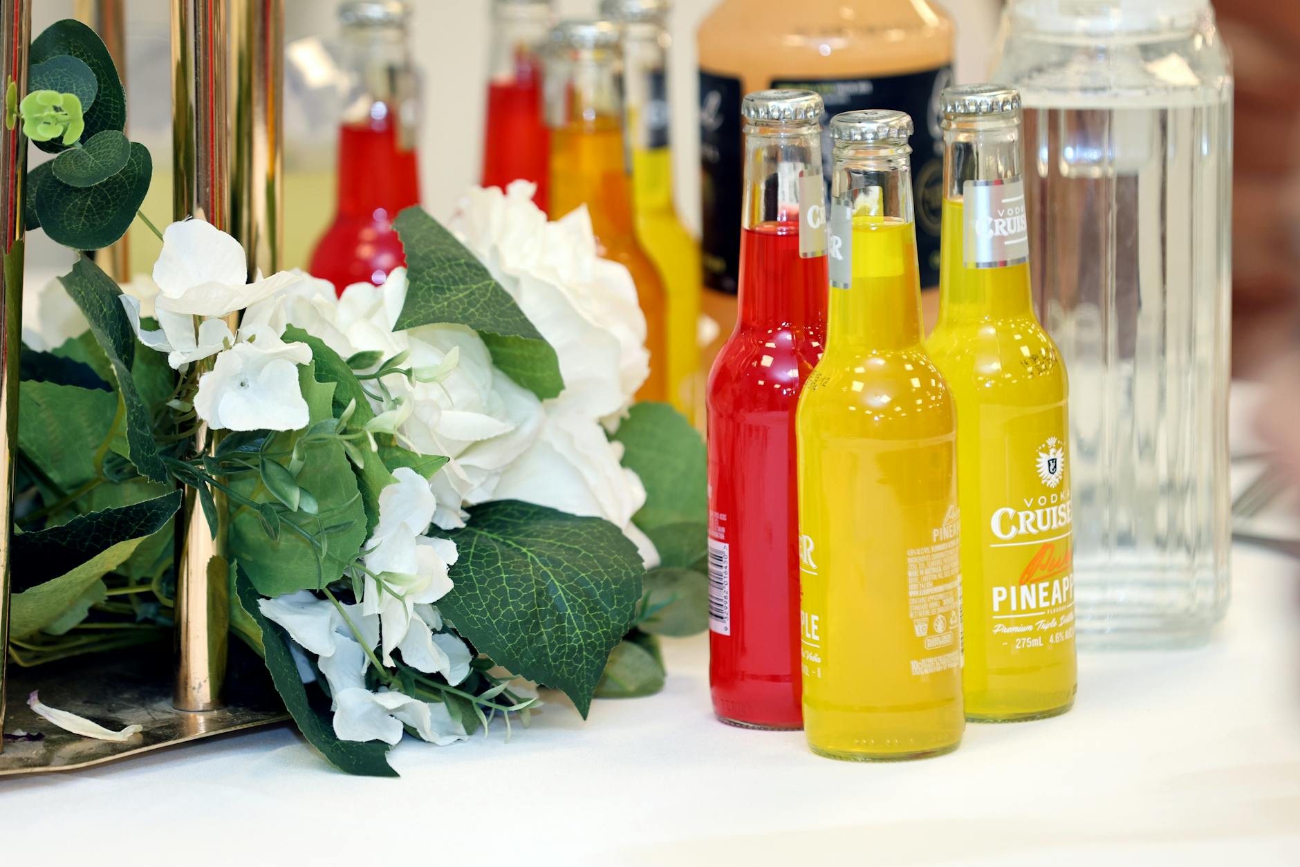 Group of friends toasting with colorful alcohol-free kombucha mocktails at a social gathering