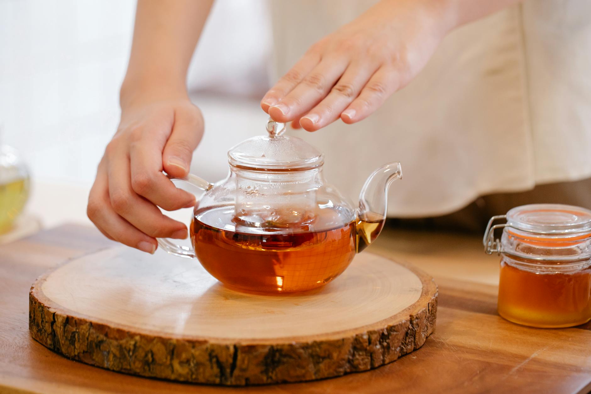 Green tea leaves and raw honey ingredients used for brewing jun kombucha at home