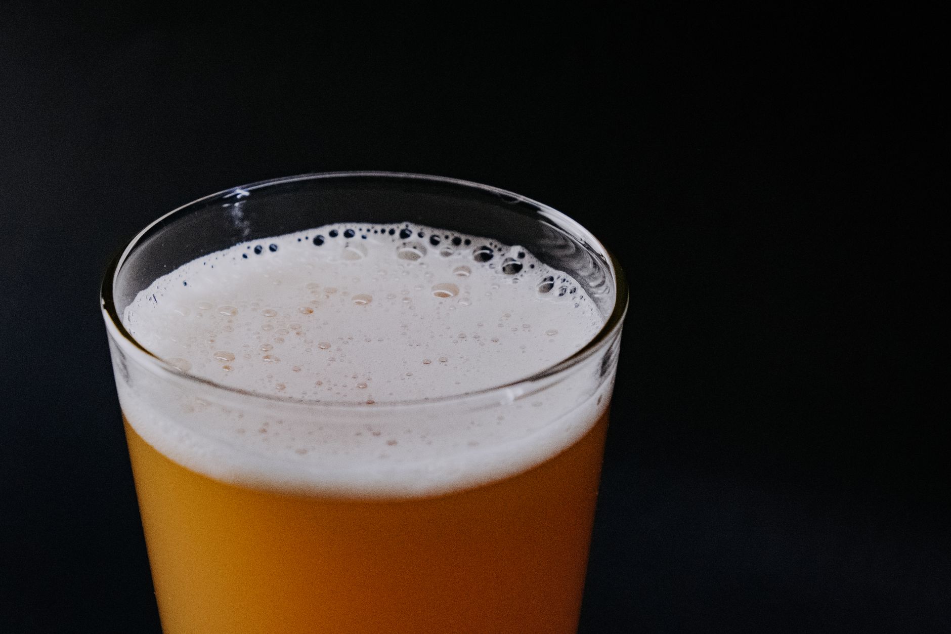 Fizzy kombucha with visible carbonation bubbles inside a sealed glass fermentation bottle
