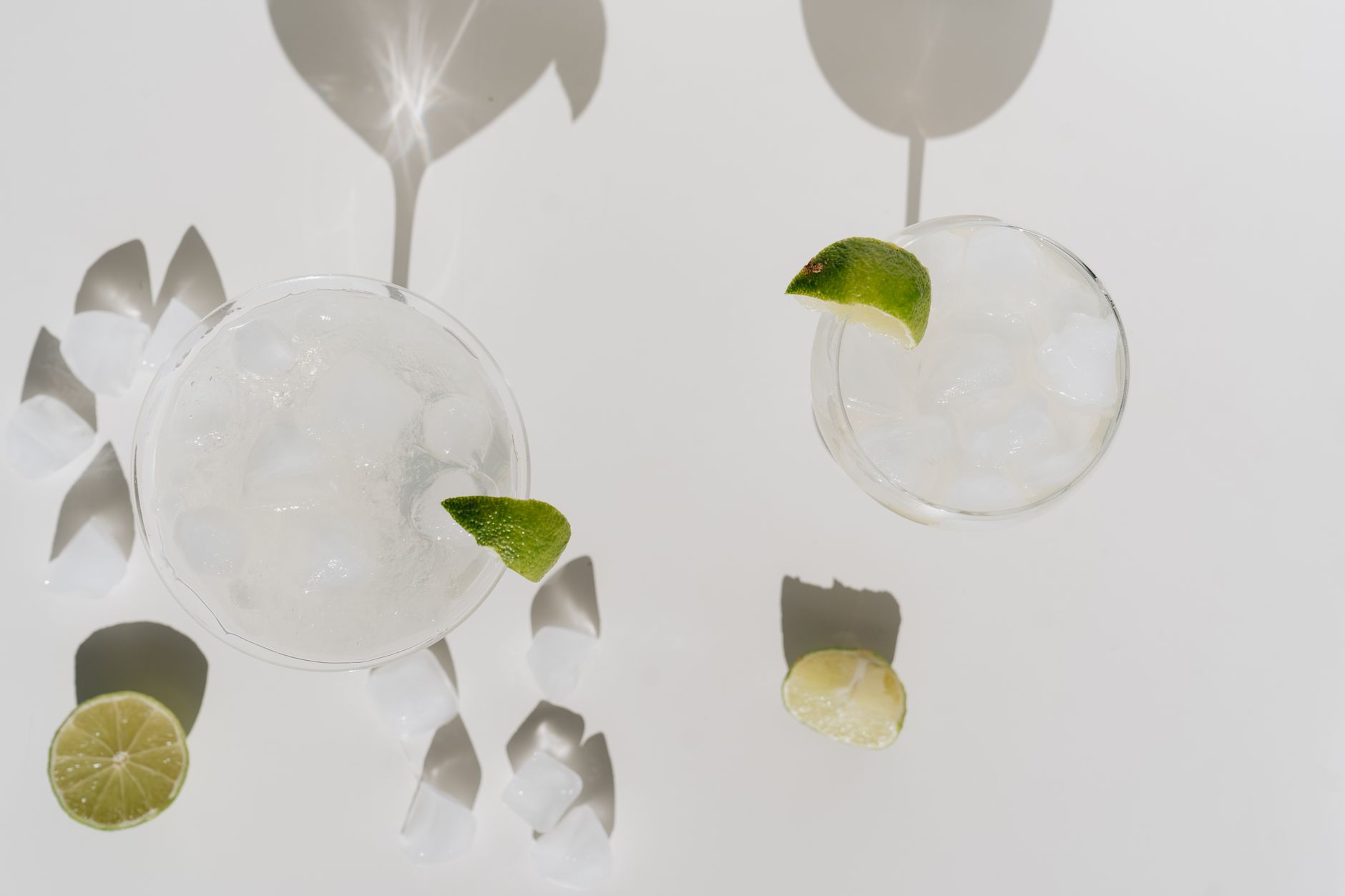 Prebiotic soda being poured into a glass with ice showing carbonation bubbles.