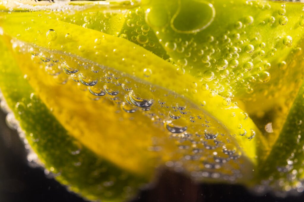 Close up of a glass jar of kombucha with visible bubbles, representing potential kombucha side effects and safe drinking tips.
