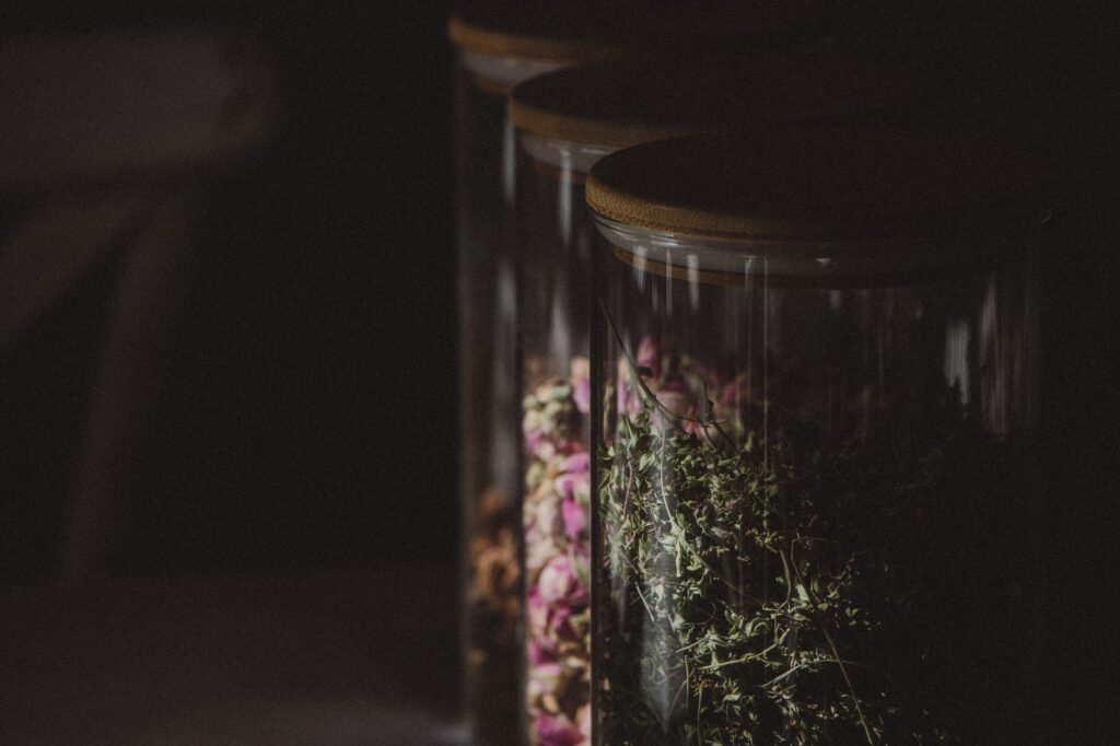 A close-up of kombucha being poured into a glass on a kitchen counter, representing questions about kombucha and blood pressure medication safety.