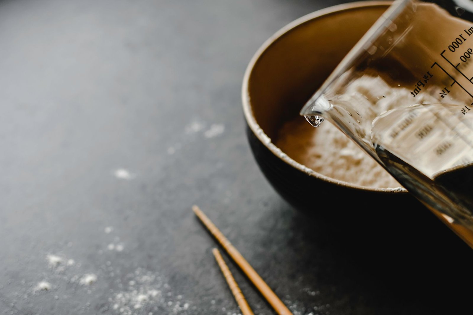 Kombucha being poured into a small 8-ounce glass to illustrate a safe daily serving size for people with diabetes.