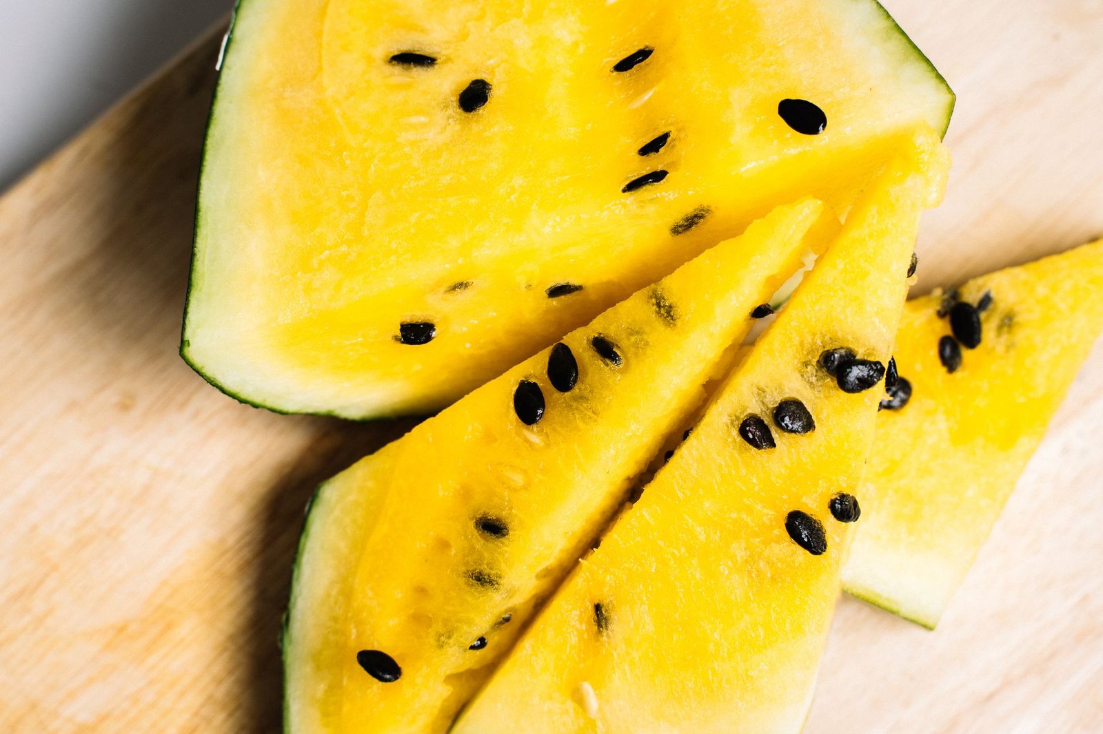 Sliced watermelon and fresh jalapeno peppers on a wooden cutting board ready for kombucha second ferment